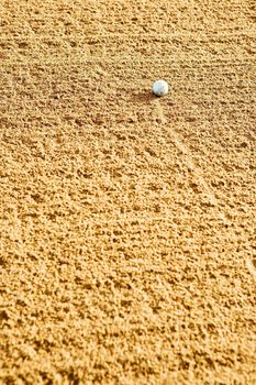 A golf ball in the bunker.