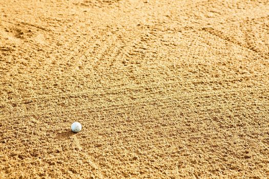A golf ball in a sand trap