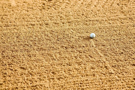 A golf ball in a sand trap