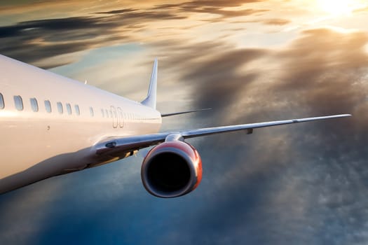 An airplane flying over a dramatic sky