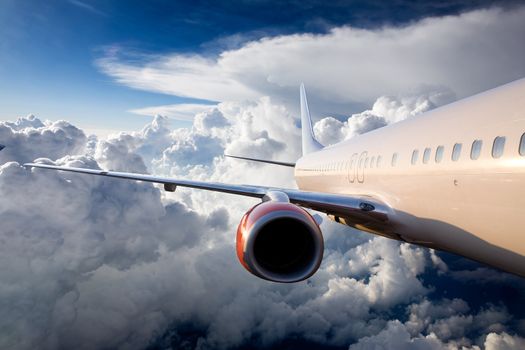 An airplane flying over a dramatic sky