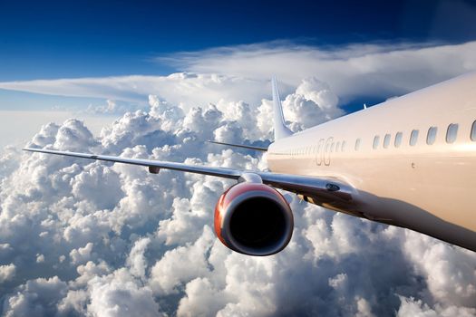 An airplane flying over a dramatic sky