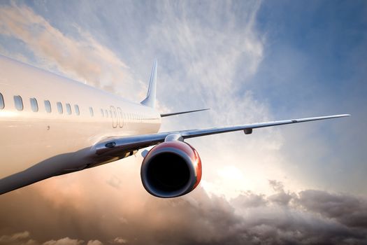 An airplane flying over a dramatic sky