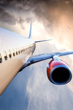 An airplane in flight over a blue sky