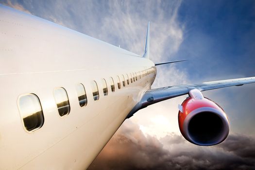 An airplane in flight over a blue sky