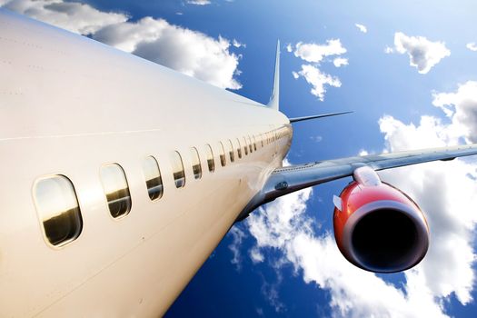 An airplane in flight over a blue sky