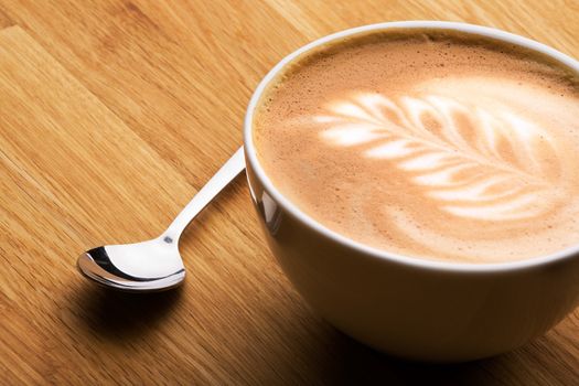 A cafe latte in a bowl with latte art