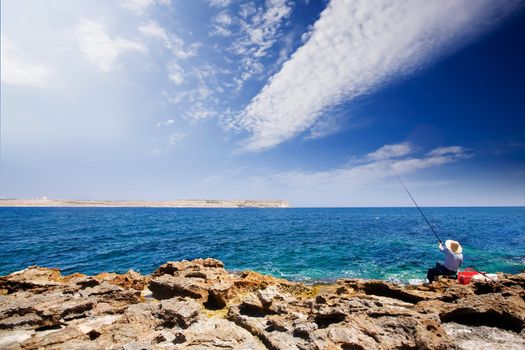 A maltese fisherman fishing in the sea