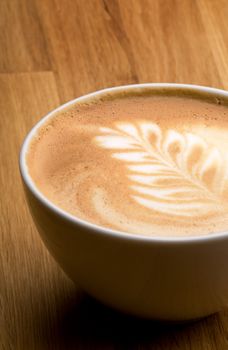 A latte in a bowl with latte art