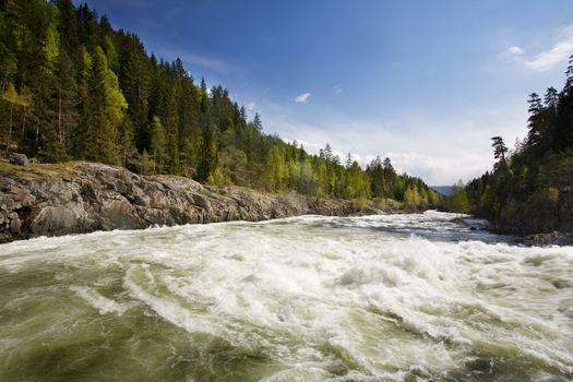 A fast moving river with white water rapids.