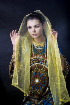 girl posing in colorful beautiful dress in the Eastern style