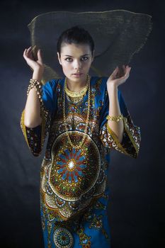 girl posing in colorful beautiful dress in the Eastern style