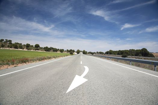 arrow sign painted on the road in spain