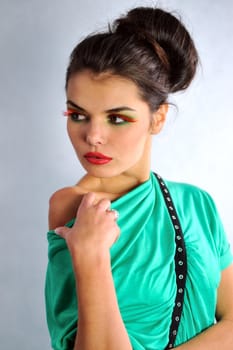 smiling girl posing in a green dress with glasses