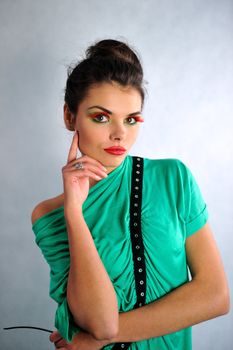 smiling girl posing in a green dress with glasses