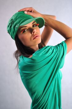 smiling girl posing in a green dress with glasses