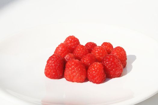Grouping of raspberries on white plate