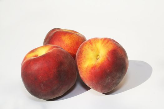 Group of peaches against white background