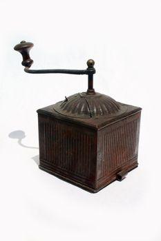 Antique spice grinder against white background