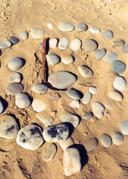 rocks in circle on sand
