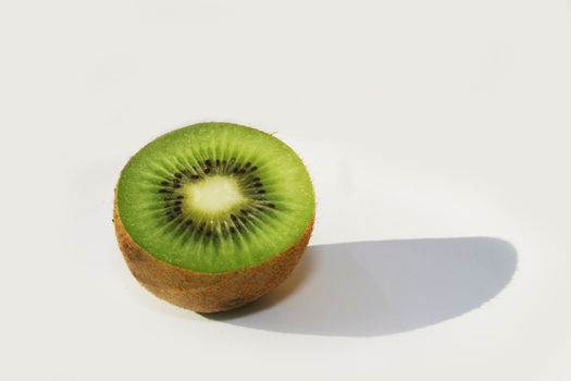 Half kiwi fruit against white background