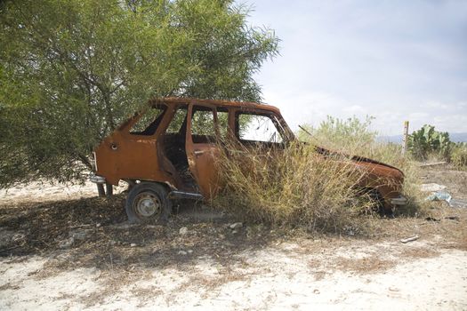 dilapidated and rusty old car at the country