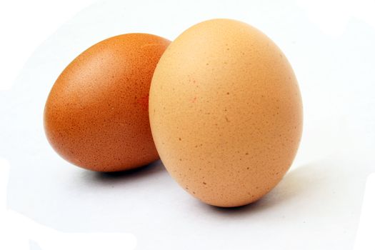 Speckled eggs against white background