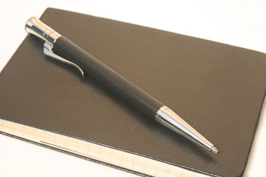 Ballpoint pen on rectangular leather notepad