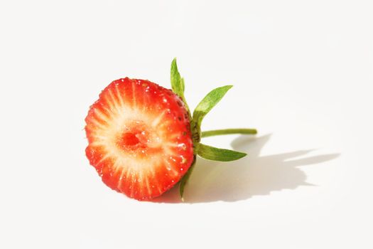 Half of a strawberry on white background with pretty shadow