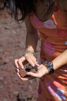 woman with volcanic stones on her hands