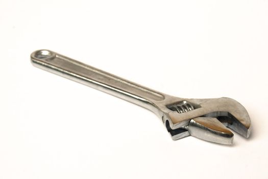 Standard chromed crescent wrench isolated against white background