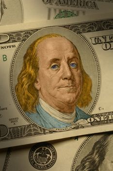 Close-up of Benjamin Franklin on the $100 bill, dramatically lit and hand-colored.