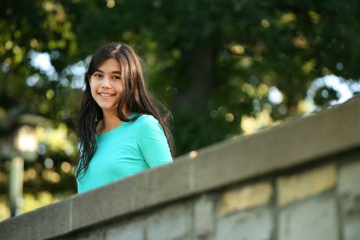 Young teen girl standing on bridge