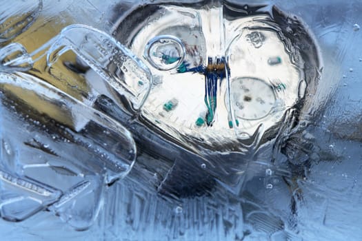 Closeup of wrist watch and water drops inside ice