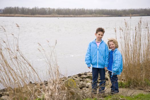 Two children standing through the water