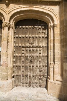 wood door of belmonte village church in spain