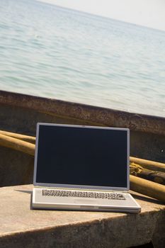 Close-up of laptop on bench of small fishing vessel