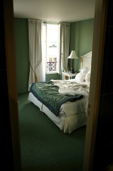 view through a door of a hotel bedroom in paris