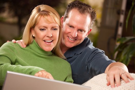 Handsome Happy Couple Using Their Laptop Together.