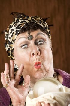 Female gypsy fortune teller with a crystal ball