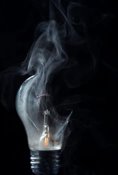 Detail of the smoking  blown-out bulb