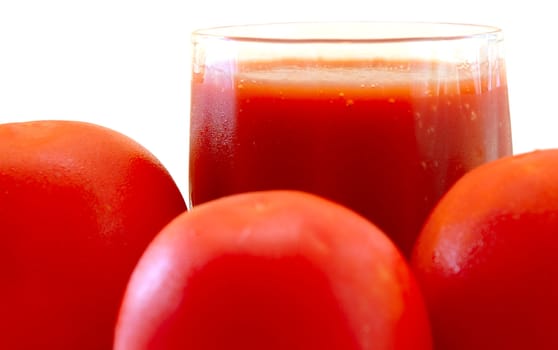 Fresh tomato juice and tomatoes on isolated background.