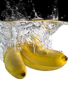 some bananas  thrown in water with black and white background