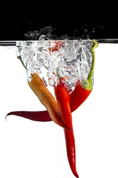 some red chilli  thrown in water with black and white background