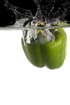 green paprika thrown in water with black and white background