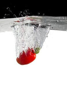 one tomato thrown in water with black and white background