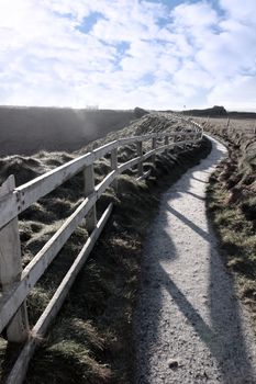 frosty winters view at ballybunion cliffside walk with atlantic view and fence shadows