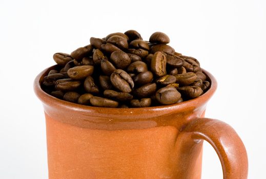 Roasted coffee and cup, white background.