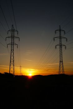 High voltage electricity pylon over sunset