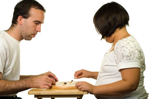 Father and daughter playing a game of tic-tac-toe